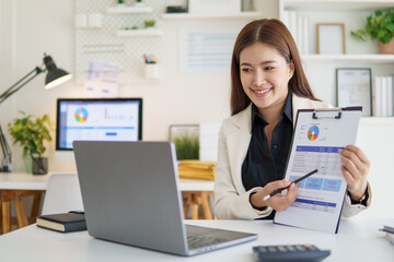 Businesswoman presenting financial report during online video meeting.