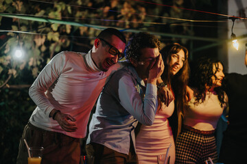 Group of friends enjoying a lively evening together outdoors, sharing laughter and joy. Decorative lights create a warm and festive atmosphere, emphasizing their companionship and celebration.