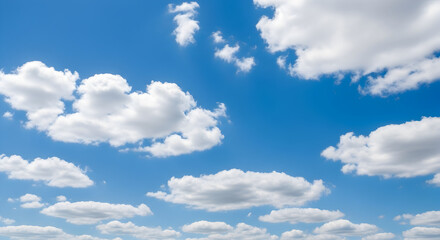 Obraz premium Expansive blue sky dotted with fluffy white clouds, creating a serene and vast aerial canvas, perfect for backgrounds or representing freedom and clear weather.