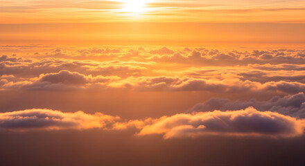 Fototapeta premium Golden Sunset Above a Sea of Clouds Aerial View