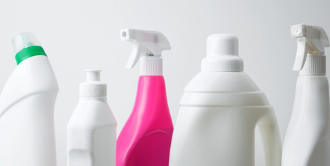 Various cleaning supplies on white background symbolizing spring cleaning. Household cleaning and...