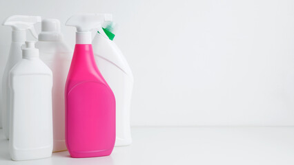 Various cleaning supplies on white background symbolizing spring cleaning. Household cleaning and...