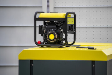A yellow and black portable generator sits on a grey surface