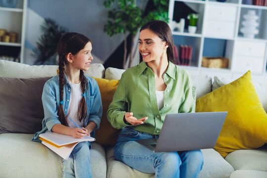 Mother and daughter bonding at home while engaging in educational activities on the sofa, fostering a strong parent child relationship. - Powered by Adobe