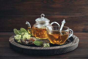 Glass cup of linden tea with glass teapot