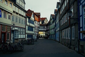 Colorful half-timbered houses line a quiet pedestrian street in the old town of Wolfenbüttel,...