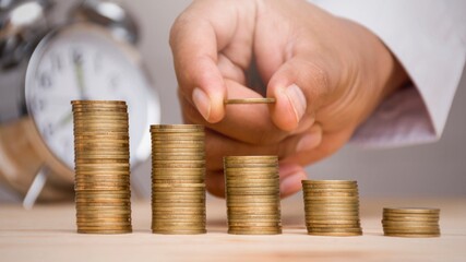 Hand stacking gold coins