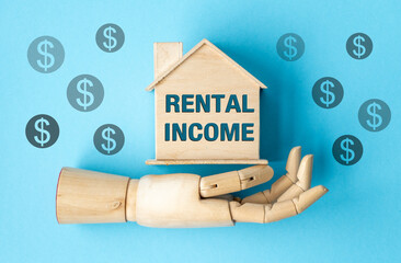 A wooden house with the word Rental Income written on it