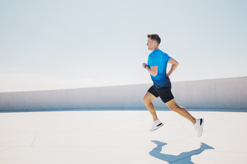 Runner sprints joyfully on a sunny day, embracing freedom and fitness during an afternoon workout...