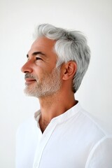 Obraz premium A warm and friendly man radiating happiness. Pure white solid background. Trendy men's curtain bangs haircut - midlife middle eastern man with middle hair. Idea of style for aging men.