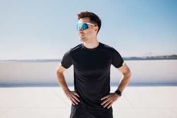 Runner enjoys a sunny day on an urban, showcasing athletic style and vibrant eyewear while...
