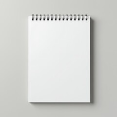Blank spiral-bound notepad on a gray surface
