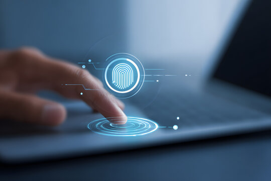 Finger touching digital fingerprint login icon on laptop. Close-up of a finger touching a glowing digital fingerprint icon on a laptop, representing biometric security, identity verification, and cybe