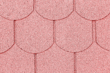 Close up of pink roofing shingles. Sparkling texture of bitumen surface. Overlapping rounded roof...