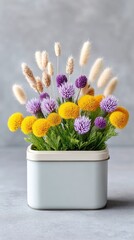 Yellow and Purple Flower Arrangement in Light Blue Square Container