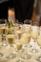 Champagne Glasses on Table at Celebration Event with Bokeh Background