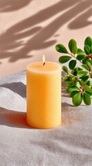 Yellow Organic Candle on Textured Linen with Soft Lighting