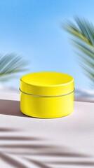 Yellow Round Tin Container Mockup on Beige Sand with Palm Leaves