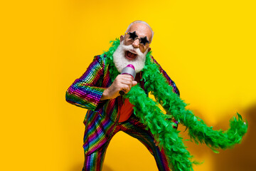 Photo of excited old man showman dance singing wear glamour striped bright clothes boa sunglass...