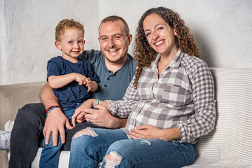 Happy family with pregnant woman expecting another baby.
Concept of maternity, parenting, preparation and expectation for baby.
