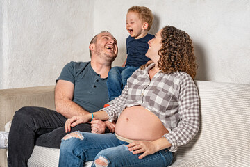 Happy family with pregnant woman expecting another baby.
Concept of maternity, parenting, preparation and expectation for baby.