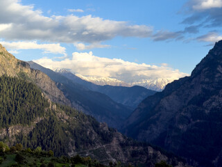 Fototapeta premium Mountain landscape with clouds as seen from Killar, Pangi Valley, India. Snow covered mountains during winter season. Nature background.