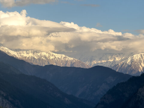 Sunset mountain landscape as seen from Killar village in Pangi Valley, Himachal Pradesh, India. Clouds on snow capped mountain peaks during sunset. Nature, Travel concept 