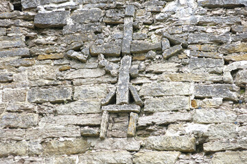 ancient stone cross on the wall of the Izborsk Kremlin