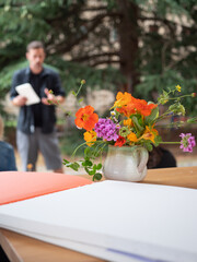 Ikebana workshop teacher explaining floral arrangement techniques