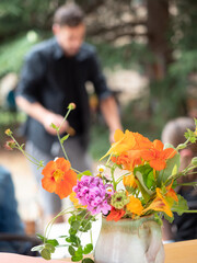 Florist creating colorful flower arrangement during ikebana workshop