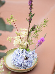 Ikebana flower arrangement with hydrangea, meadowsweet and purple loosestrife