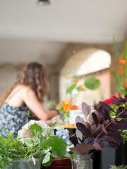 Florist creating ikebana arrangements during workshop