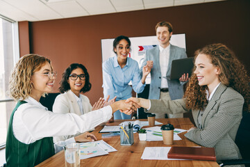 Business professionals collaborating during a meeting in a welcoming workplace environment to foster teamwork and project development