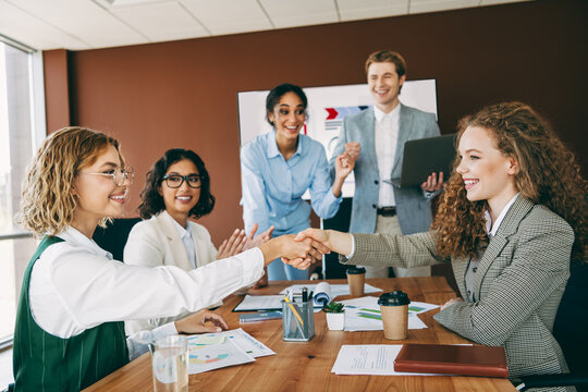 Business professionals collaborating during a meeting in a welcoming workplace environment to foster teamwork and project development