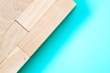 Light-colored wooden blocks, arranged at an angle, create a contrasting diagonal division with a...
