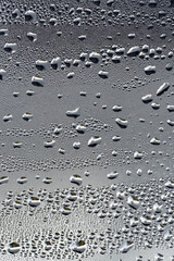 background, unusual, abstract. drops of morning dew, condensation on the glass. wet glass. water drops close-up. beautiful background for text. Spray cool condensate water on the glas