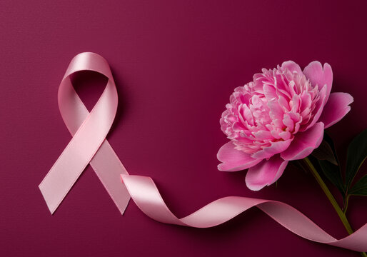 Pink ribbon and peony flower on a dark pink background for breast cancer awareness campaign support symbol