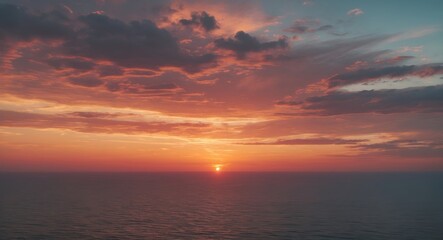 Sunset over the ocean with colorful clouds and a calm sea, beautiful natural scenery.