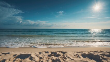 Obraz premium A serene beach scene with the ocean, sandy shore, and bright sun illuminating the sky.
