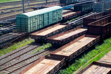A long line of train cars is currently arranged neatly on the tracks