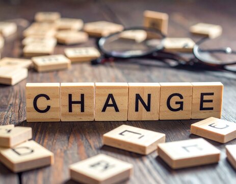 "CHANGE" Wooden Blocks on Rustic Wood with Blurred Bokeh Lights