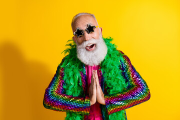 Photo of excited old man showman show pray gesture wear glamour striped bright clothes boa sunglass...
