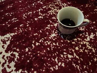 a cup of coffee on the carpet
