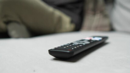Remote control lying on sofa in living room