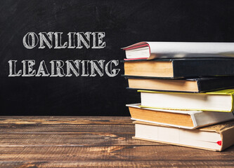 Stack of books with the word online learning written on top