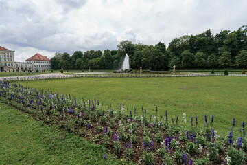 Beautiful garden landscape with fountain and flower beds at a historic palace in summer