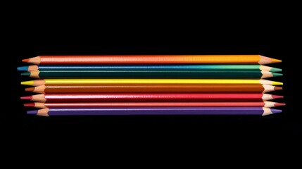 Eight colored pencils arranged in a row against a black background.
