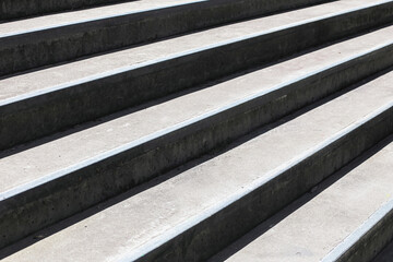 Concrete stairs closeup view. Outdoor stone staircase background. Urban geometry and shadow...