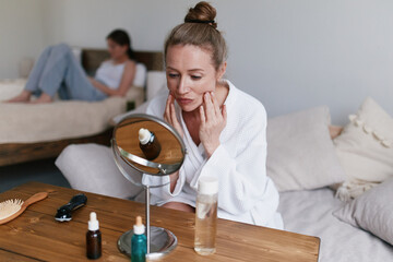 Middle age woman practicing healthy skincare routine at home promoting wellness and wellbeing