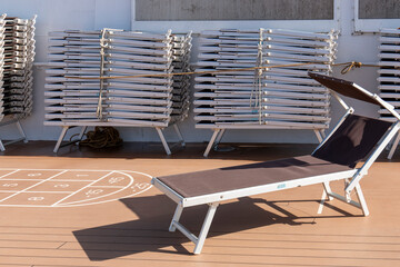Sun loungers stored on the deck of a cruise ship